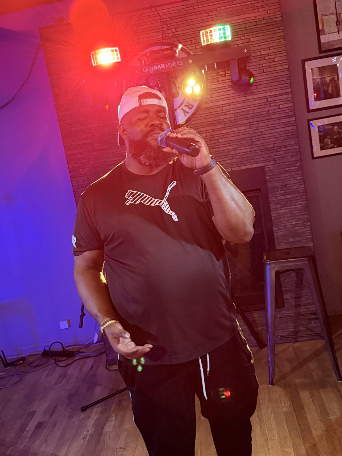 Guest performer singing karaoke with dramatic lighting at 18th Street Brewery Gary Indiana