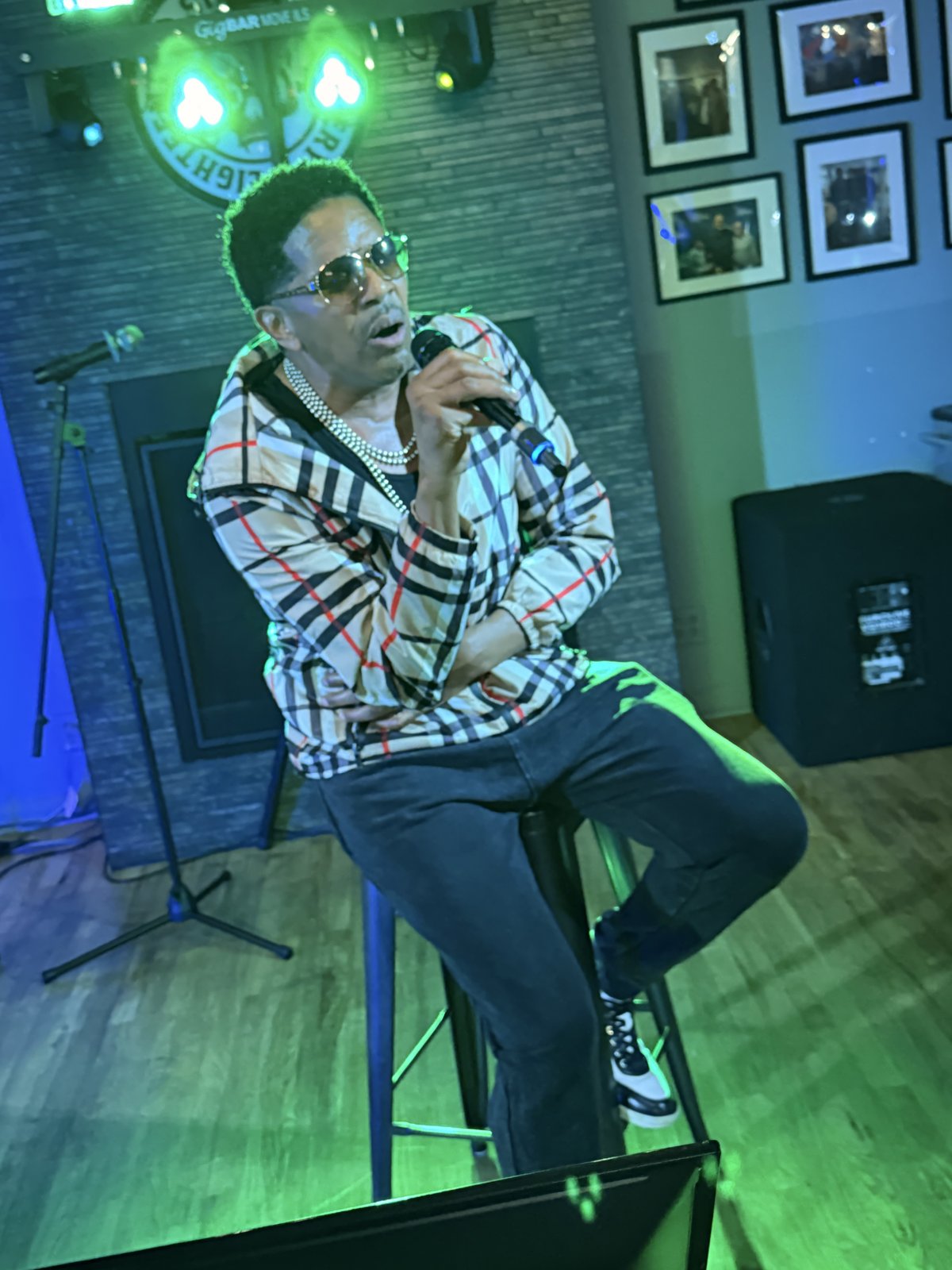 Singer seated on stool performing karaoke at 18th Street Brewery Gary Indiana